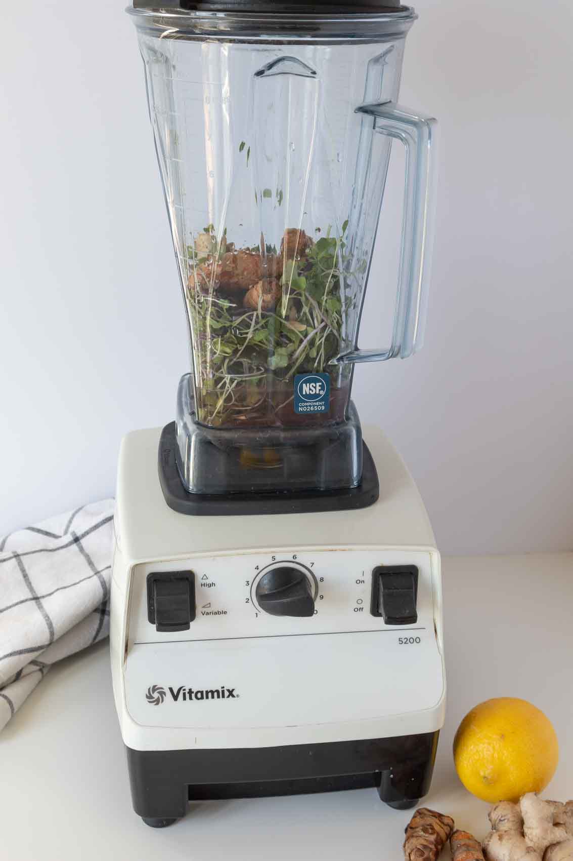 Process shot of adding ingredients to the blender.
